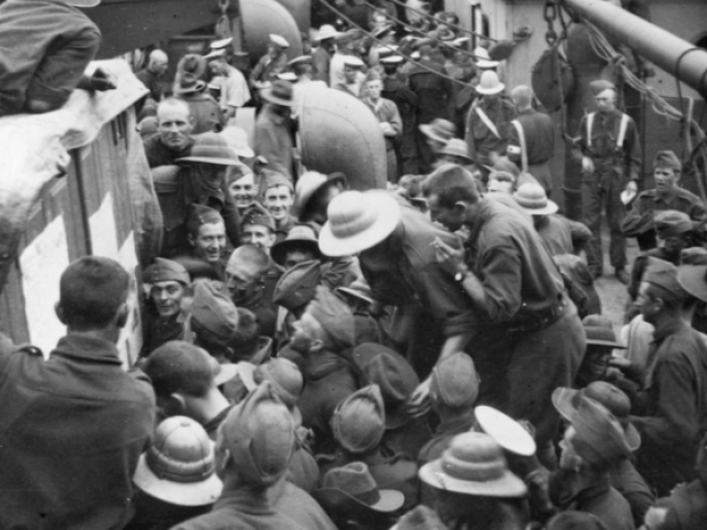 Members of the Australian Naval and Military Expeditionary Force (AN&MEF) crowd around the bulletin board on the troopship Berrima bound for New Britain, Sept 1914