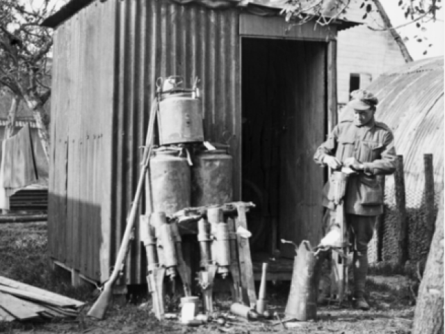 Corporal Ernest Lionel Bailey, 51st Battalion and later Australian Corps Salvage AIF, tagging battlefield trophies for the Australian War Museum at the Hoograaf Collecting Depot, 1917