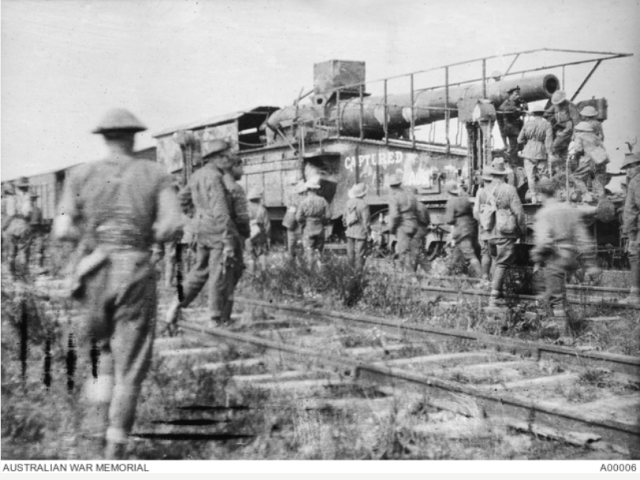 Men of the 23rd Battalion inspecting the 28cm German railway gun, (known as the Amiens gun) after its capture by AIF troops, 9 August 1918