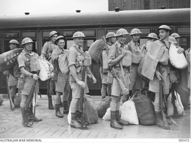 Sydney, NSW. Members of the 2/19th infantry battalion detrain and prepare to board a ferry to take them to their assigned ship which is waiting to transport them to Malaya. 5 February 1941.