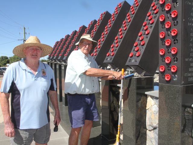 ANZAC DAY PREPARATIONS: Narrabri RSL Sub-branch president Gary Mason OAM and Bill Pownall clean the light columns on the Narrabri War Memorial on Tuesday.