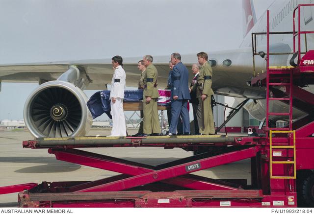 The bearer party transfers the coffin from the Qantas flight ‘Spirit of Remembrance’ at Sydney Airport.