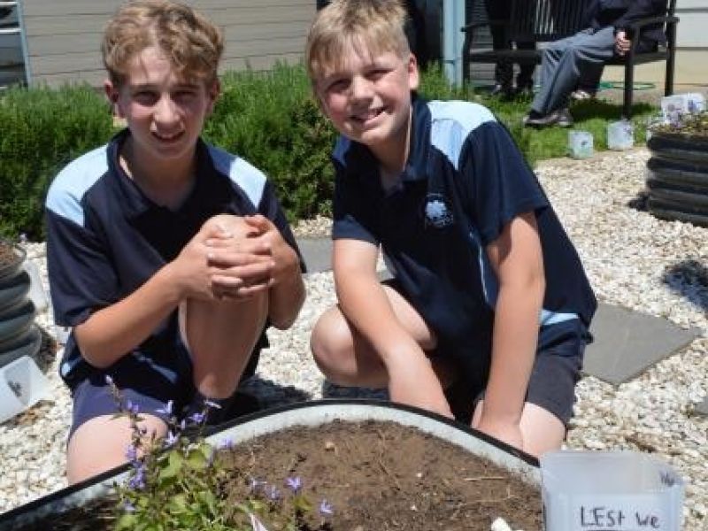 REMEMBERING CHARLIE: Moorak Primary School captains Ben Harfull and Ethan Brook in the Charlie Miller Memorial Garden watched on by Heather Cram representing Gambier Earth Movers who donated a large rock for the garden, Christy Wallace who painted the sign, Principal Peter Mitchinson, Penne Paltridge the teacher who began the project, and Mount Gambier RSL President Bob Sandow seated who officially opened the garden.