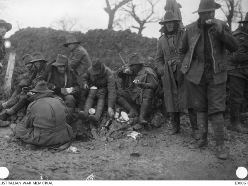 A fatigue party of the 22nd Battalion, road mending between Montauban and Mametz, having their midday meal by the roadside, Dec 1916