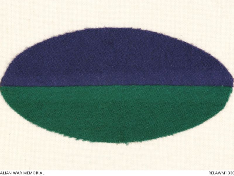 Horizontally aligned oval shaped colour patch for 34 Infantry Battalion AIF, divided purple over green.