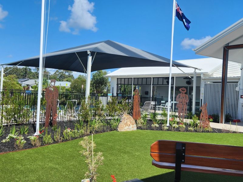 Memorial garden showing sculptures, flagpoles and seating 