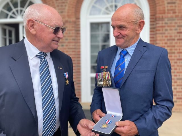 Macaulay Cottrell (left) and the son of the late Kevin Wheatley, George, (right) were presented with the Silver Stars at a ceremony at the US Embassy.(ABC News: Craig Allen)