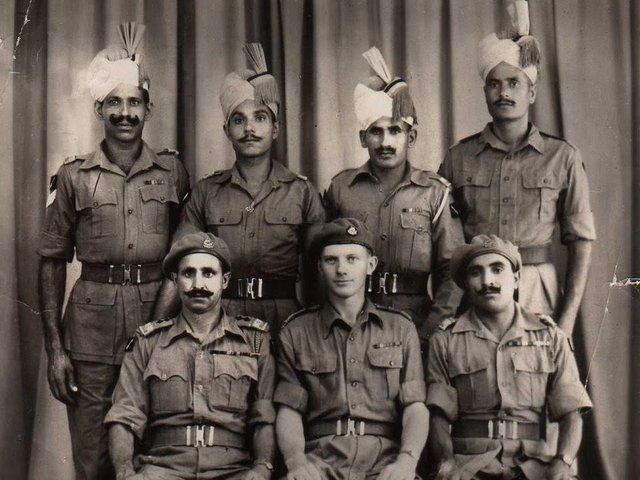 A regimental group photo of British-Indian Commandos who fought off a Japanese attack in Assam, India, WW2