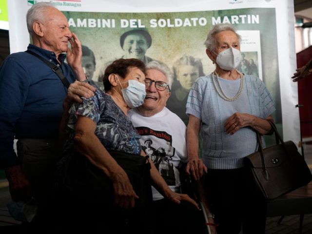 Veteran Martin Adler poses with Bruno (left), Mafalda (right) and Giuliana (center) Naldi. Thanks to social media and a dogged journalist, the 97-year-old reconnected with the three siblings after 77 years. (AP Photo / Antonio Calanni)