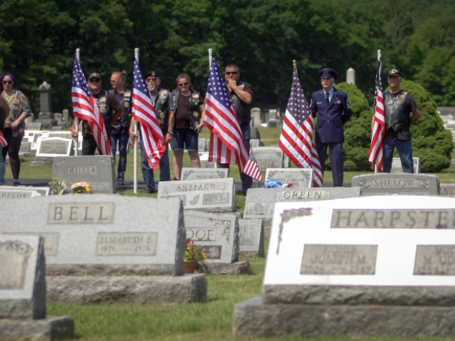 Veterans hold American flags at the funeral for Cpl. Paul Wilkins at Logan Valley Cemetery Saturday, June 16, 2021 in Bellwood, Pa. The Army declared Wilkins missing in action in July 1950 during the Korean War, and his remains were finally discovered 70 years later. Walter was a teenager the last time he saw his brother. (Lauren Schneiderman/The Philadelphia Inquirer via AP)