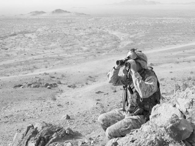 Black and white photo of a soldier looking through binoculars from 'An-My Lê: On Contested Terrain' is on view at the Fort Worth Museum in the US through Aug 8
