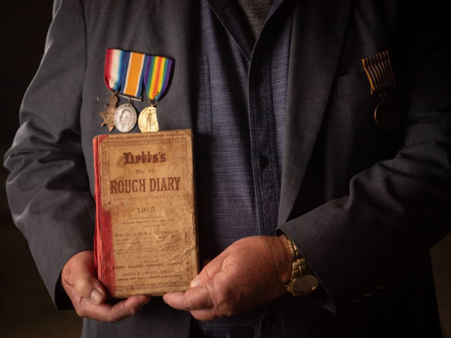 Malcolm Milliken holds his uncle Morris Milliken’s World War I diary. CREDIT: EDDIE JIM