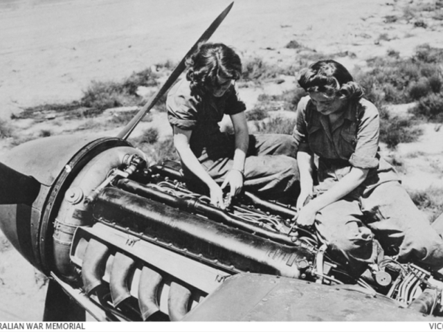 Williamtown, NSW. C. 1944. Two WAAAF Flight Mechanics, Aircraftwoman (ACW) Lee and Paddy Whitlock of Burwood, NSW, working on an engine of a De Havilland Mosquito aircraft at No. 5 Operational Training Unit.