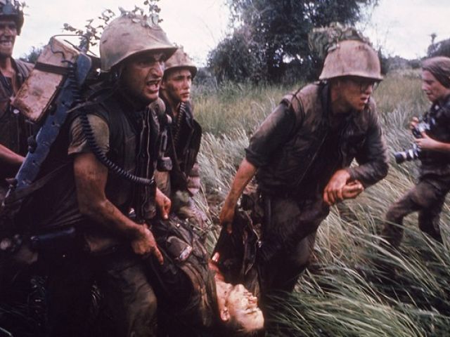 Marines recovering a dead comrade while under fire in South Vietnam. Photographer Catherine LeRoy holds cameras behind them. Credit: LARRY BURROWS / THE LIFE PICTURE COLLECTION / GETTY