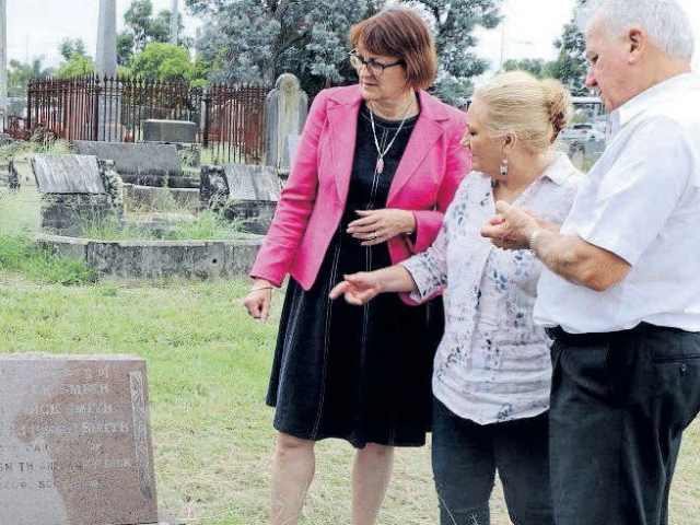 Susan Templeman, Mary Lyons-Buckett and Alan Leek standing next to John Smith's grave, the only person to attend Mr Whirpool's funeral, in February