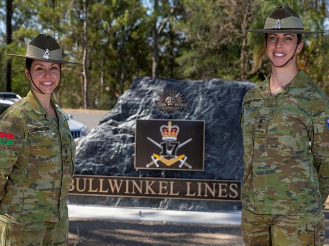 Army Nurses Stand in front Stone Monument that marks the entrance to the 17th Brigade Bullwinkel Lines