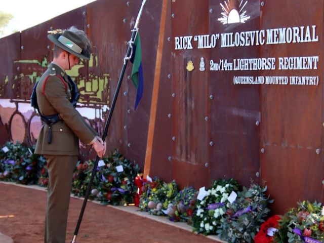 A soldier pays respect at the Stjepan 'Rick' Milosevic Memorial in Quilpie.(ABC Western Qld: Melanie Groves)
