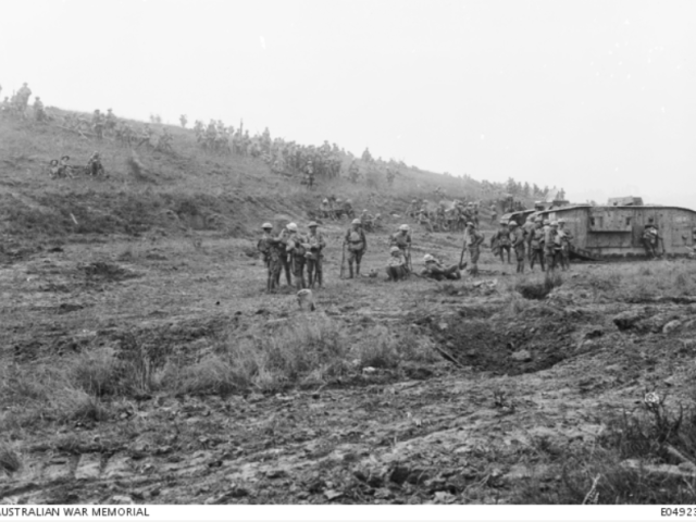 Unidentified troops of the 5th Australian Infantry Brigade, with their kit and rifles, resting on a hillside. Amiens, 8 August 1918