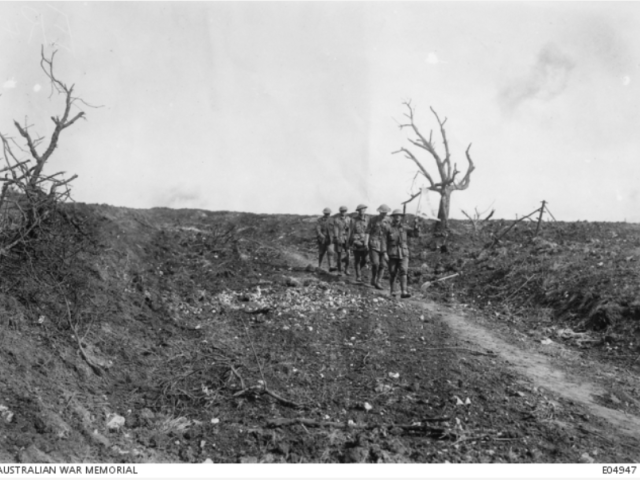 Australian stretcher bearers coming in under a white flag, passing the old cemetery of Pozieres, near Mouquet Farm, August 1916