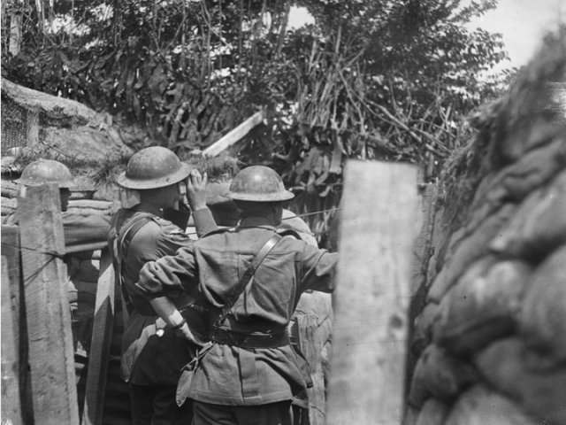 Australians in the trenches near Hill 63, the day prior to the battle of Messines Ridge, in Belgium, looking through field glasses at the village of Messines, 5 June 1917. 