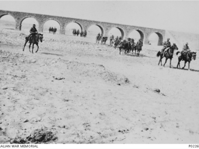 Mounted troopers from the 4th Light Horse Brigade outside Beersheba, November 1917. Standing undamaged in the background is Beersheba’s famous railway bridge which was built by the Ottoman regime and which the Turks had not had time to destroy before the light horsemen captured the town