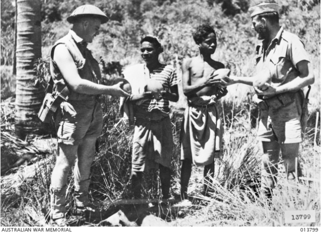 Australian guerrillas accepting fresh fruit from Timorese in November 1942