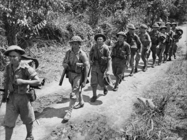 Men of the 55/53rd Battalion march into the front line, Papua New Guinea, Northern Province, Gona, New Guinea: Sanananda, December 1942
