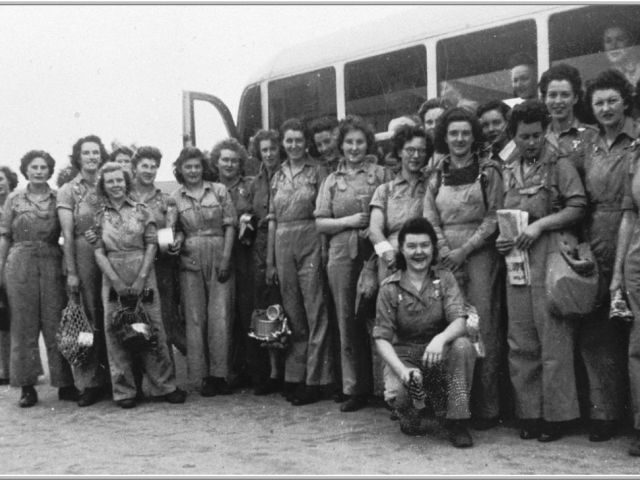 Large group of Land Army girls described as the 'Toora Vale Mob' by bus transport at Berri, South Australia.