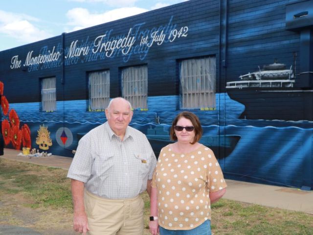 Lest we forget: Stanhope RSL secretary George Gemmill and Stanhope and District Development Committee president Glenda Cowie at the Stanhope mural being painted by artist Tim Bowtell. 