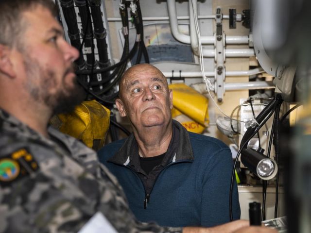 Nephew of Ordinary Seaman the late Edward 'Teddy' Sheean VC, Gary Ivory, watches Chief Petty Officer Kerrin Lyon steer the submarine HMAS Sheean during a sea ride. Photo: Leading Seaman Daniel Goodman