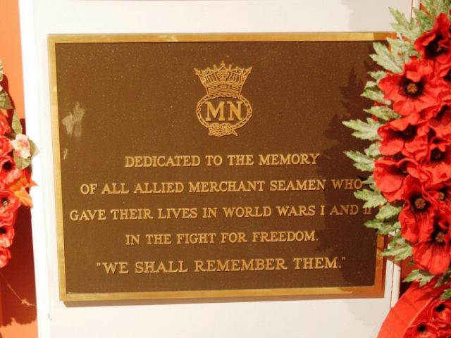 A simple plaque displaying the Merchant Navy insignia and the dedication