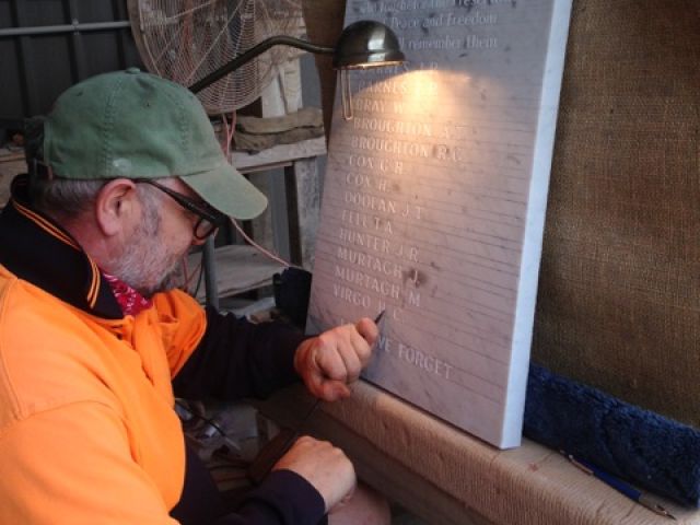 Stone mason engraving the Veteran's names