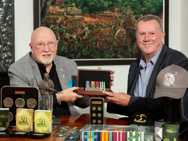 Vietnam Veteran Wayne Lyons with 50th anniversary commemorative medallion designer Steve Rainey at the Military Shop in Fyshwick. Photo: Michelle Kroll.