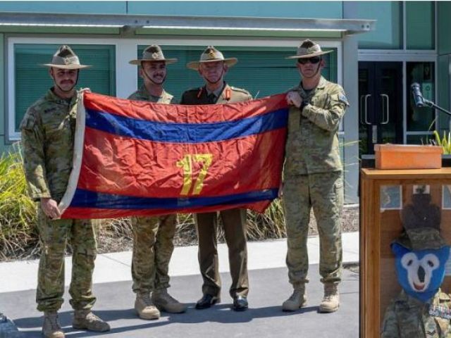 From left, Officer Commanding 17th Construction Squadron Major Lincoln Barbare, flag orderly Sapper Jack Miles, Major General Stephen Day and Squadron Sergeant Major 17th Construction Squadron Warrant Officer Class Two Taj Whelan with the returned flag at RAAF Base Amberley, Queensland. Photo: Warrant Officer Class Two Kim Allen