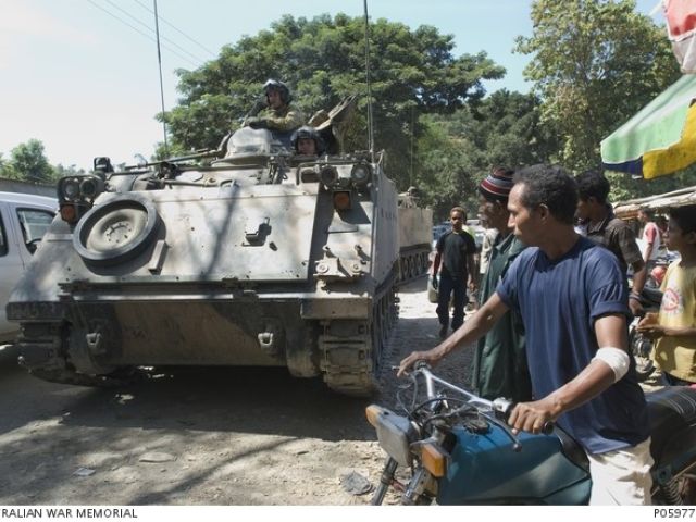  During the period of the East Timor Presidential Election, ADF soldiers patrol Dili streets aboard armoured personnel carriers (APCs).