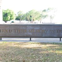 The laser-cut panel declaring "WE HOLD THEIR MEMORY IN TRUST"