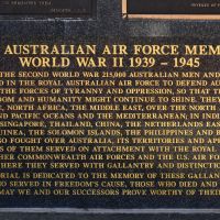 The dedication panel at the base of one side of each of the three plinths