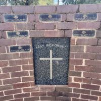 Commemorative wall behind the stone and plaque