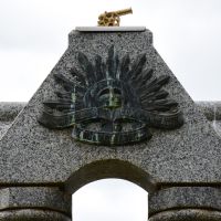 The emblem used by the Australian Imperial Force, with a small brass cannon atop the Memorial