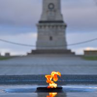 Flame of Remembrance and Reflection Pool during evening Golden Hour.