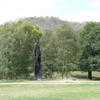 The statue of the Australian Serviceman stands, with Mount Ainslie in the background