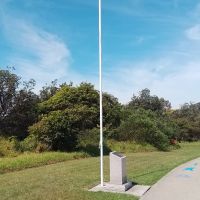 The commemorative cairn and flagpole
