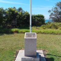 The commemorative cairn and flagpole