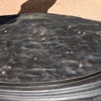 The silver disks in the base of the artwork