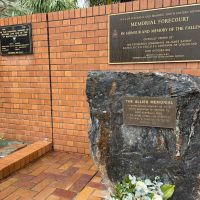 Plaque of interest to the left, with the forecourt