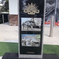 Australian Military Forces badge, with two photographs, "Courage" written at base of monument
