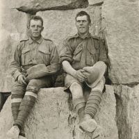 Informal portrait of 47 Private (Pte) Thomas Anderson Whyte (sitting left) and 159 Sergeant John Rutherford Gordon sitting on one of the large stones of the Great Pyramid at Giza.