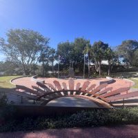 Rising sun sculpture facing war memorial and amphitheatre to the right