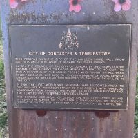 The first of eight large plaques in a semi-circle behind the memorial