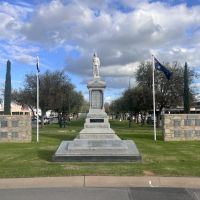 War Memorial with walls on either side bearing plaques listing those who served in WW2